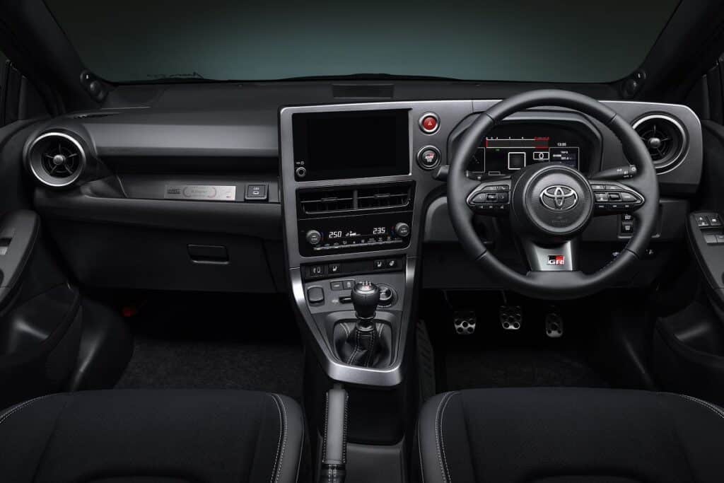 Le volant, doté de surpiqûres bleu, blanc, rouge, ajoute une touche de raffinement aux éléments sportifs de l’intérieur - © Toyota